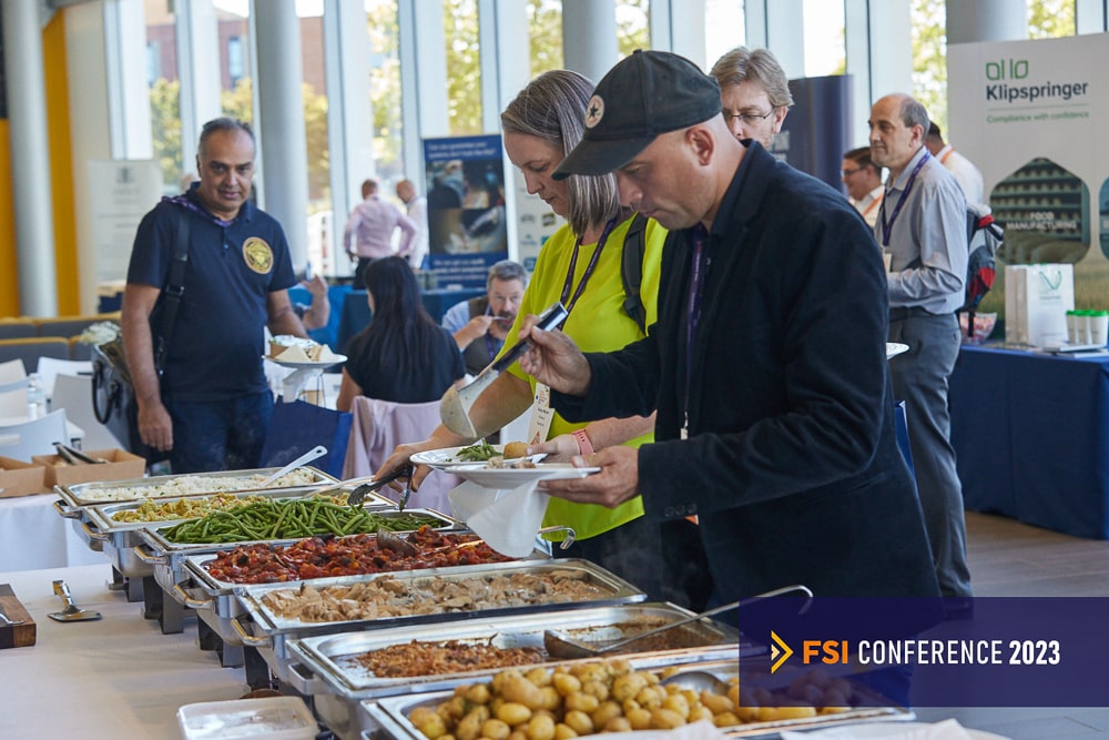 People taking food from a buffet